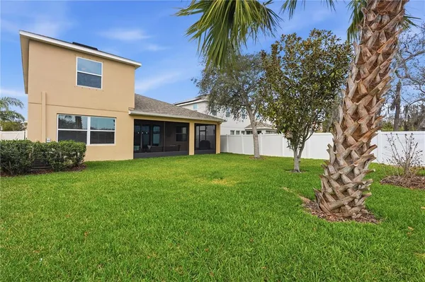 a view of house with a yard