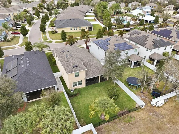 an aerial view of residential houses with outdoor space and swimming pool