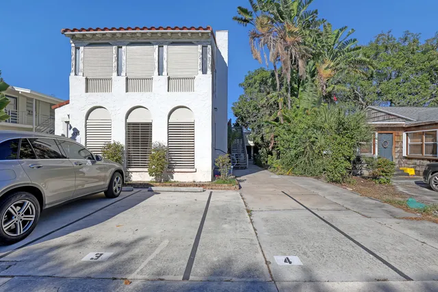 a couple of cars parked in front of a house