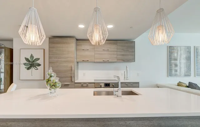 a kitchen with granite countertop a sink and a stove