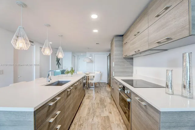 a kitchen with a sink and a stove top oven