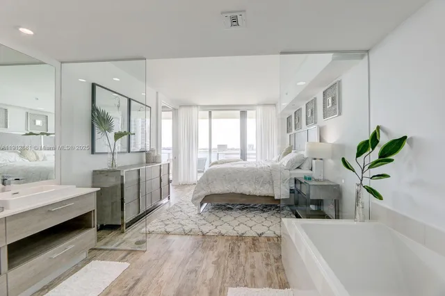 a bathroom with a double vanity sink and mirror with shower