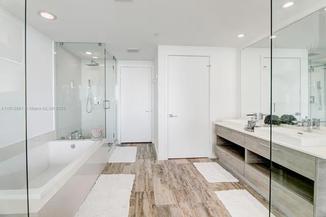 a white bath tub sitting next to a shower