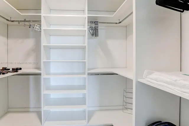 a large bed sitting in a bedroom next to a window