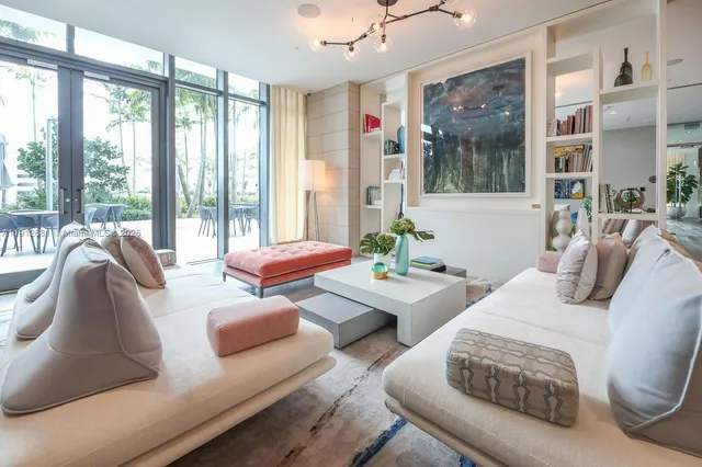 a pool table with view of living room and wooden floor