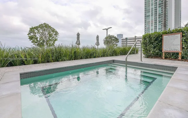 a dining room with furniture and a chandelier