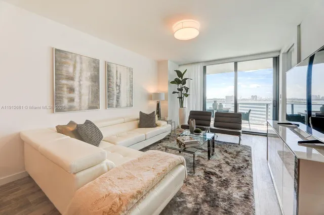 a living room with furniture and large windows