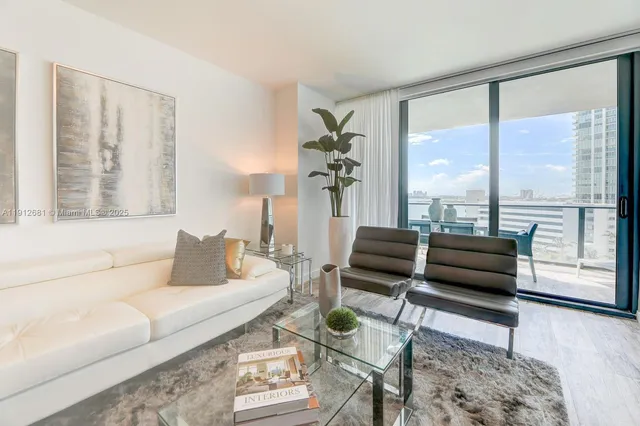 a living room with furniture and a large window