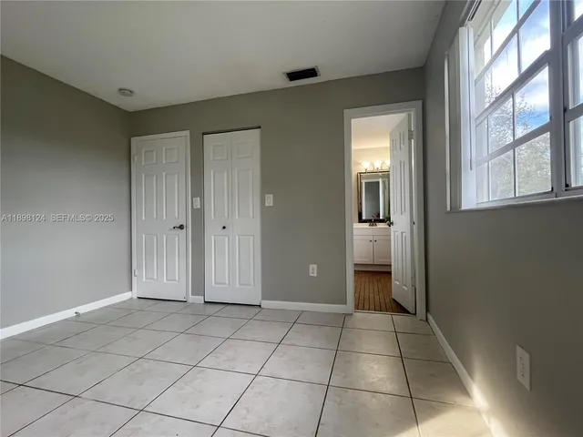 a view of a livingroom with an empty space and a window