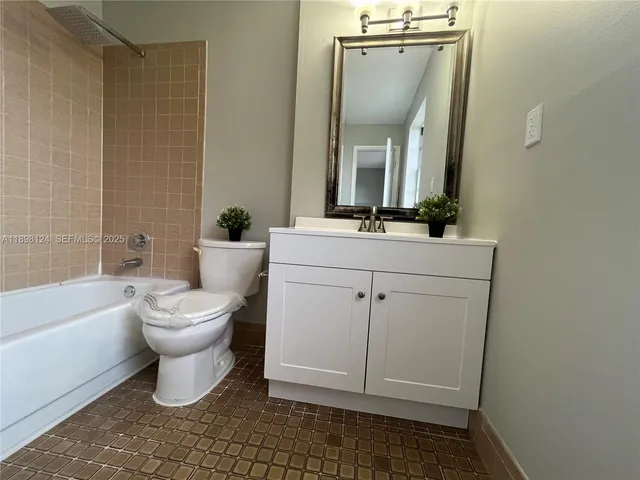 a bathroom with a sink a toilet and bathtub