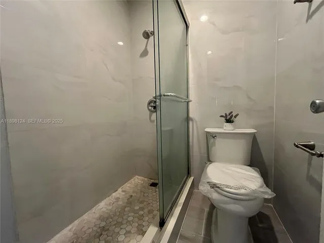 a bathroom with a toilet sink and shower