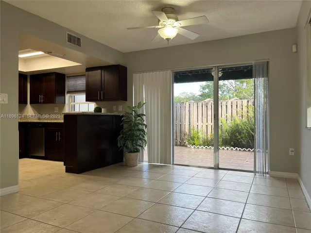 a living room with a large window and a flat screen tv