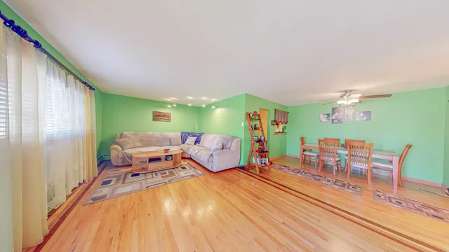 a bedroom with furniture and a wooden floor