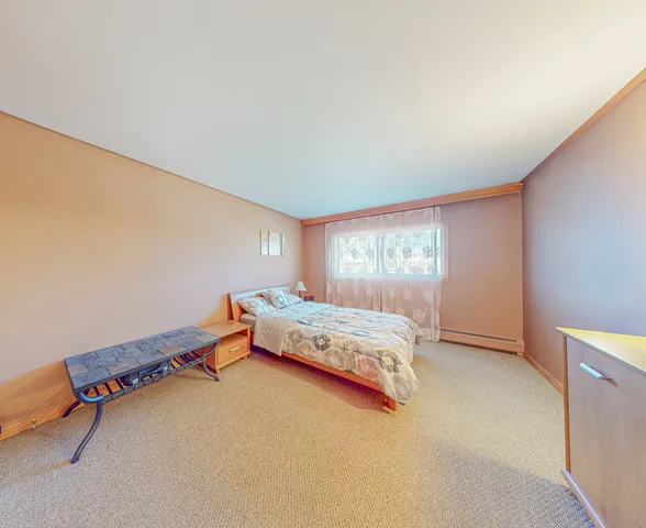 a bedroom with a bed and window