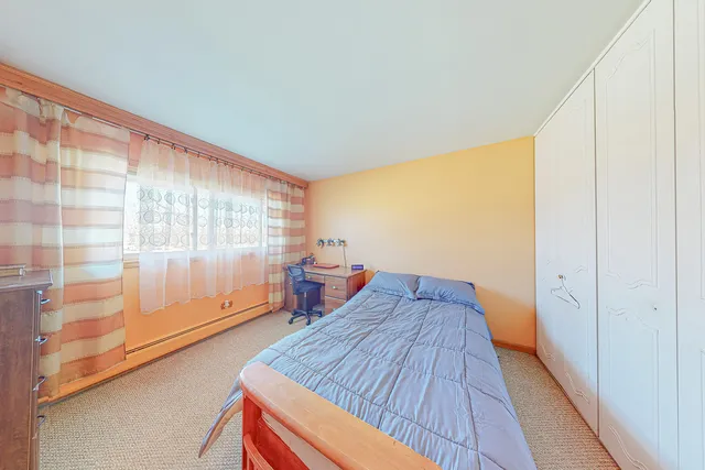 a bed room with a bed and a large window