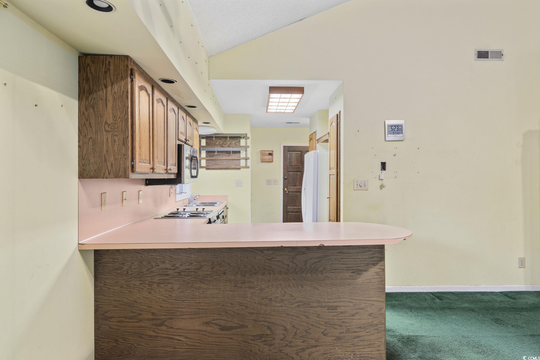 1647 Running Water Road Murrells Inlet, SC 29576 - Photo 11 of 39 Kitchen featuring kitchen peninsula, white fridge,