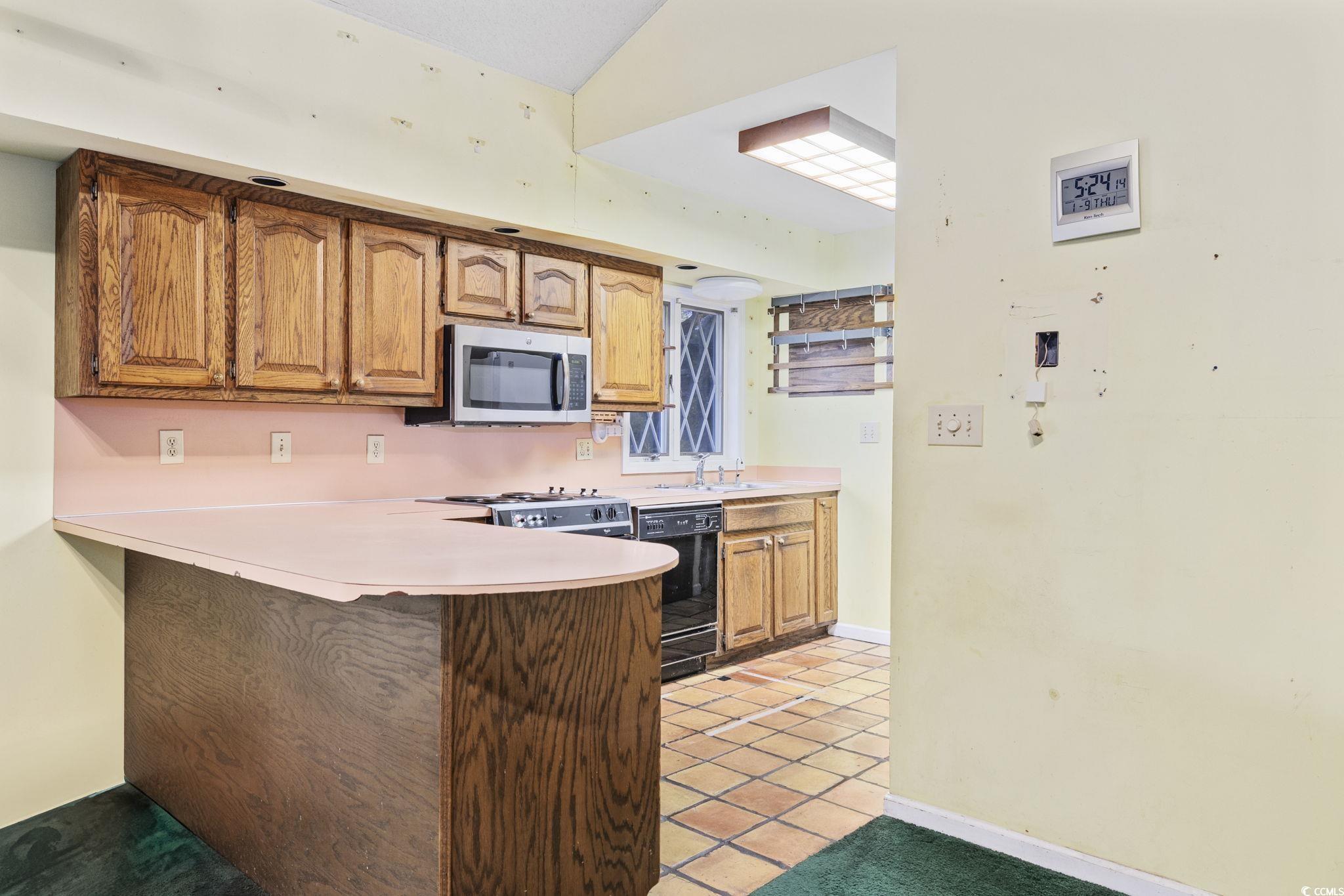 1647 Running Water Road Murrells Inlet, SC 29576 - Photo 12 of 39 Kitchen with dishwasher, sink, vaulted ceiling, li