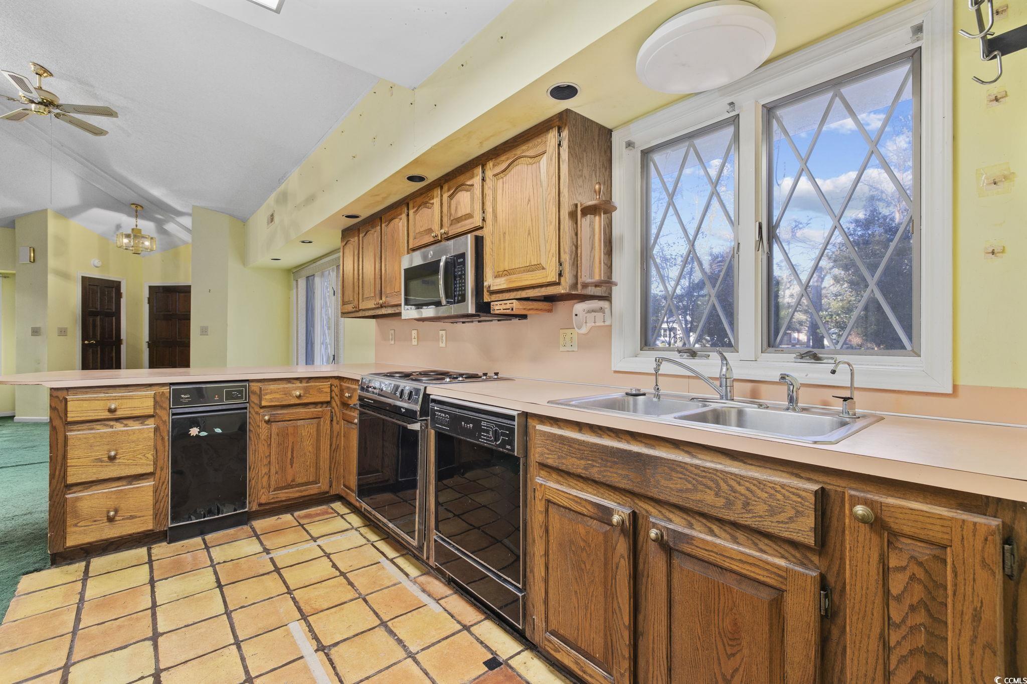 1647 Running Water Road Murrells Inlet, SC 29576 - Photo 13 of 39 Kitchen with ceiling fan, sink, black dishwasher,