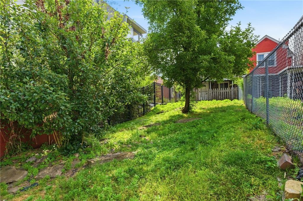 4824 Harrison Street Pittsburgh, PA 15201 - Photo 2 of 11 a garden with trees in the background