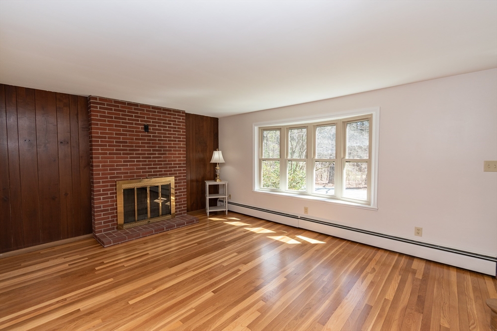 60 Crooked Spring Road North Chelmsford, MA 01863 - Photo 6 of 25 an empty room with windows fire place and refrigerator
