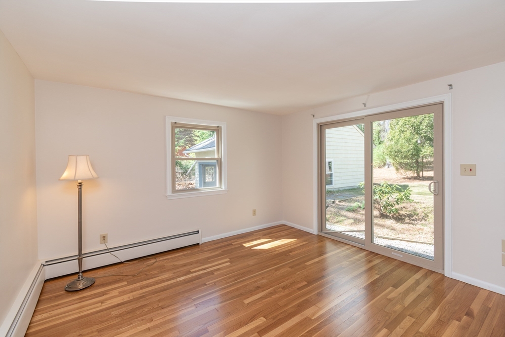 60 Crooked Spring Road North Chelmsford, MA 01863 - Photo 8 of 25 a view of an empty room with wooden floor and a window