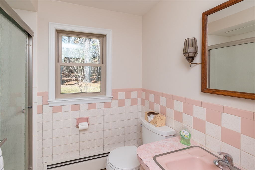 60 Crooked Spring Road North Chelmsford, MA 01863 - Photo 10 of 25 a white toilet sitting next to a bathroom sink