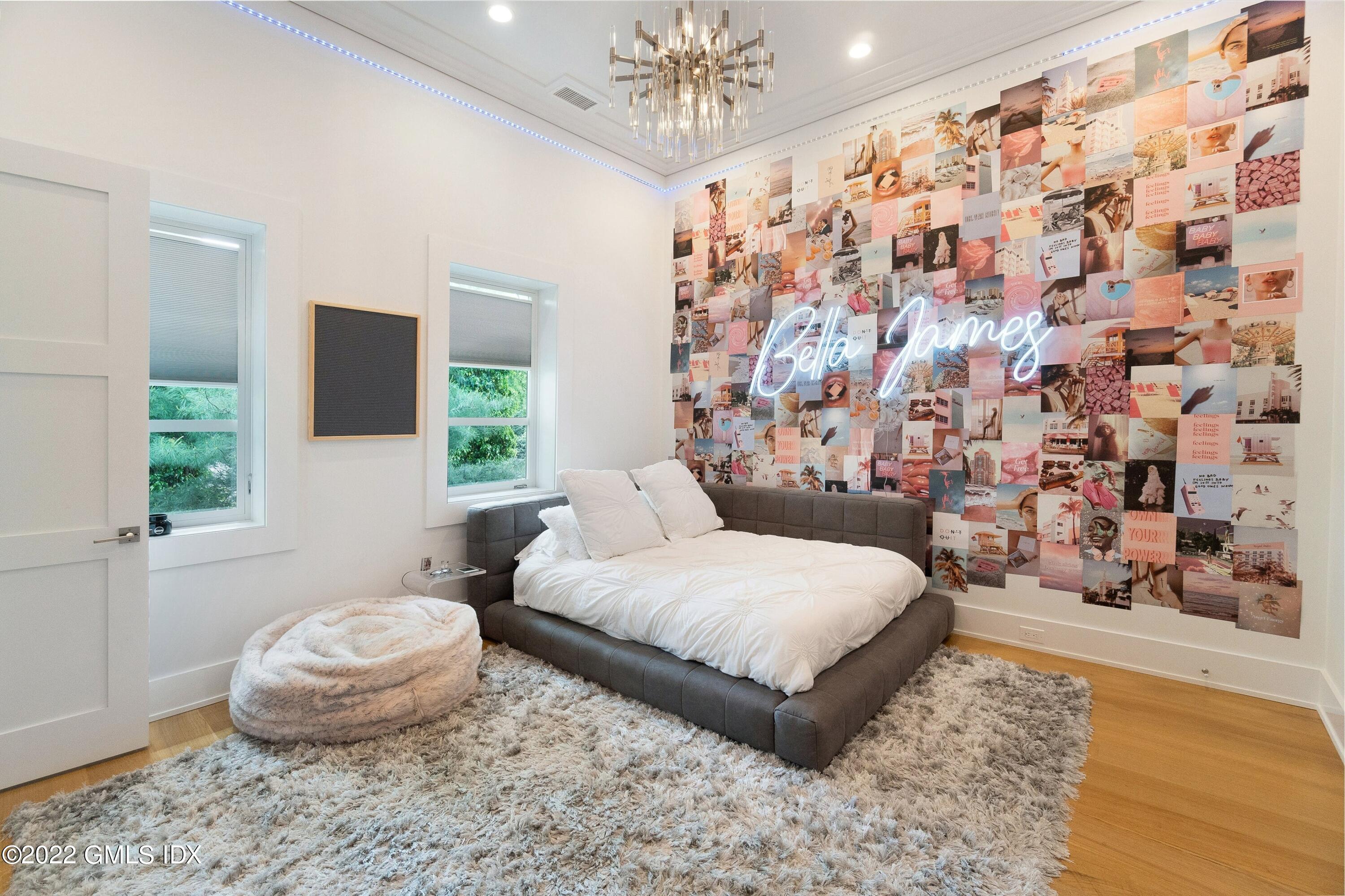 22 Oak Drive Riverside, CT 06878 - Photo 25 of 40 a spacious bedroom with a bed and a chandelier