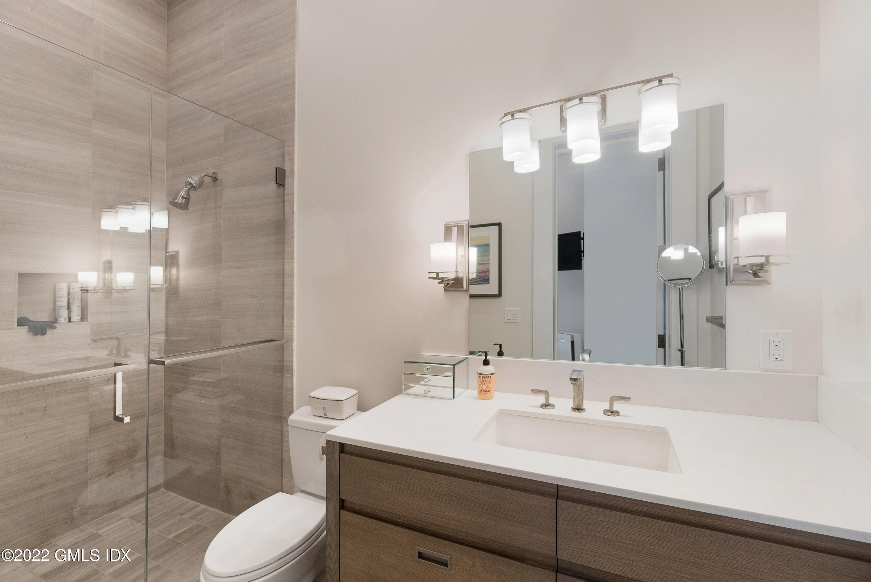 22 Oak Drive Riverside, CT 06878 - Photo 27 of 40 a bathroom with a sink a toilet and shower