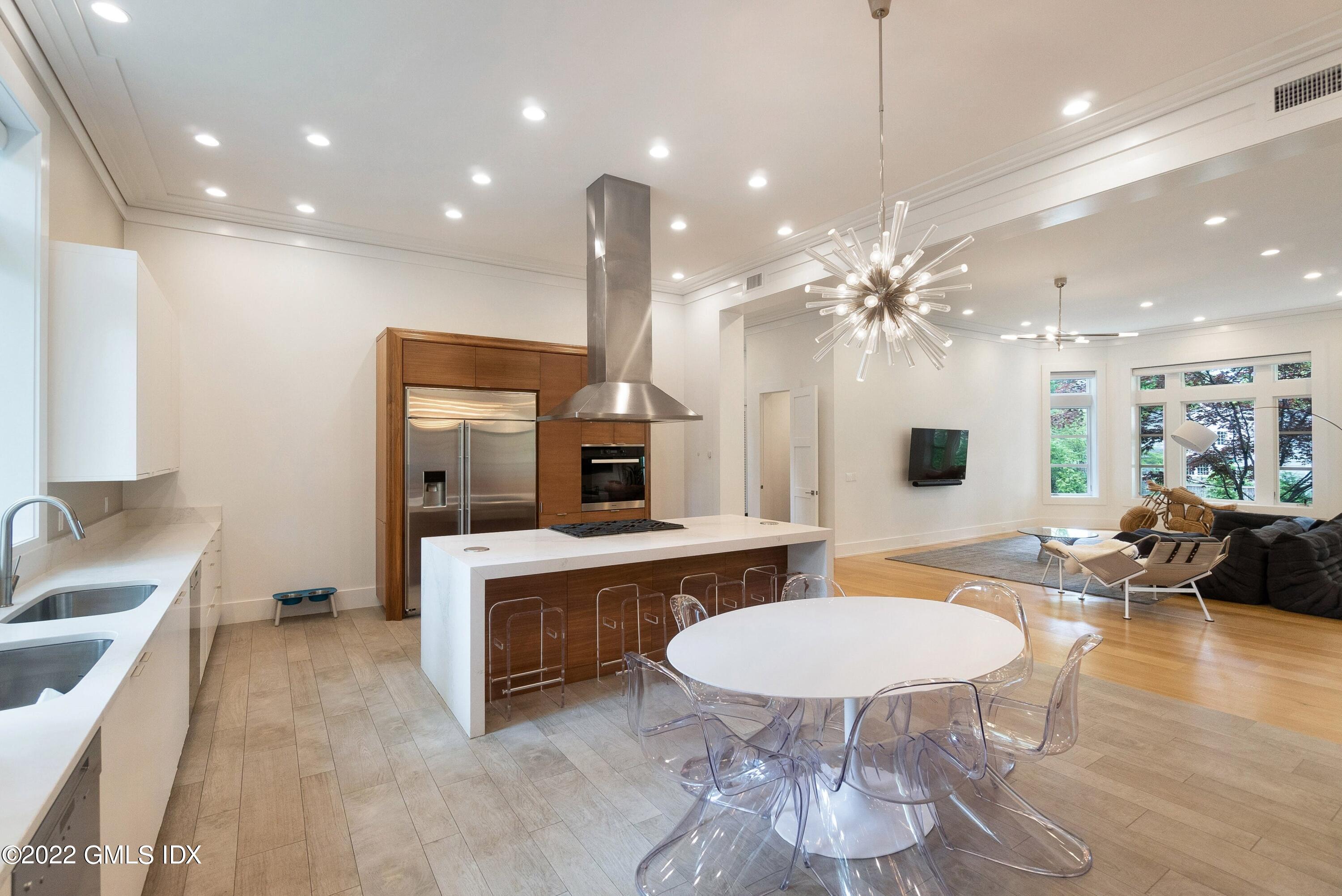 22 Oak Drive Riverside, CT 06878 - Photo 4 of 40 a large kitchen with a table and chairs