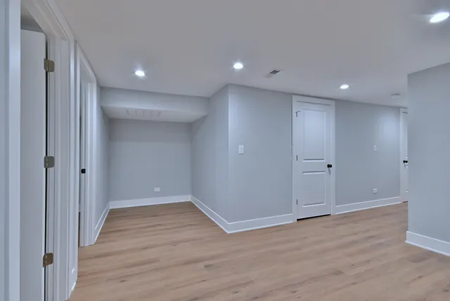 a view of hallway with wooden floor