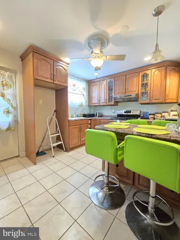 a bedroom with furniture and a large window