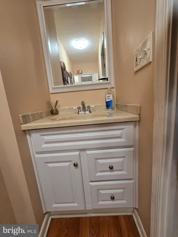 a kitchen with a sink a stove a microwave cabinets and a dining table