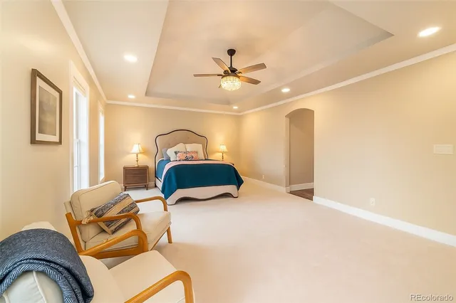 a bedroom with a bed and ceiling fan