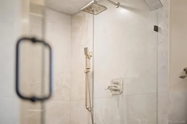 a bathroom with a glass shower door