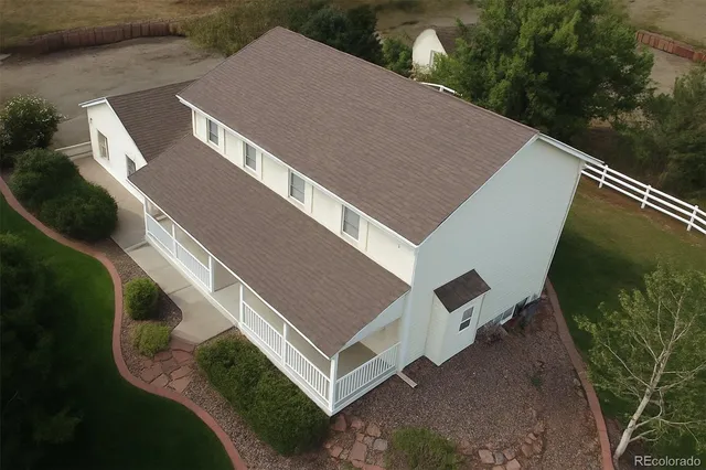 a aerial view of a house with pool table and chairs