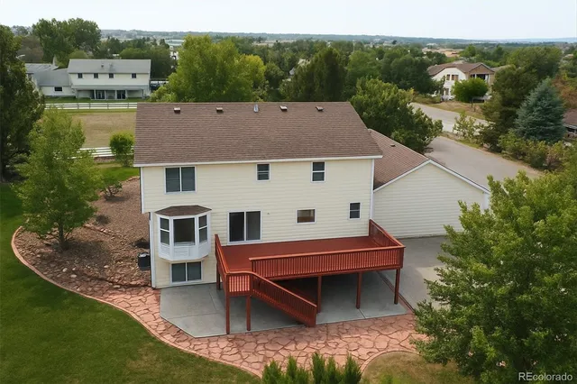 an aerial view of a house with a yard and lake view