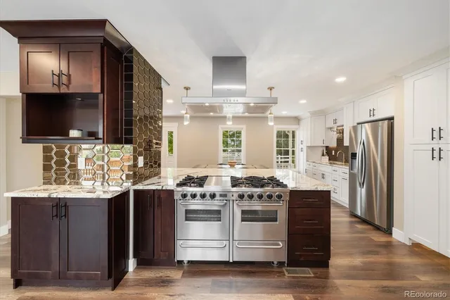 a kitchen with stainless steel appliances a stove a sink and a refrigerator