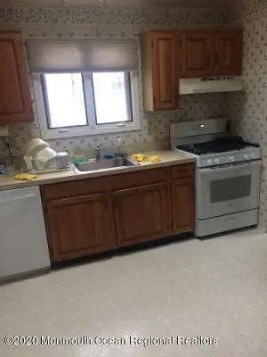 a kitchen with stainless steel appliances granite countertop a sink stove and microwave