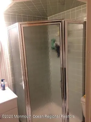 a bathroom with a glass shower door