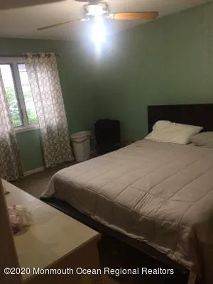 a bed sitting in a bedroom next to a window