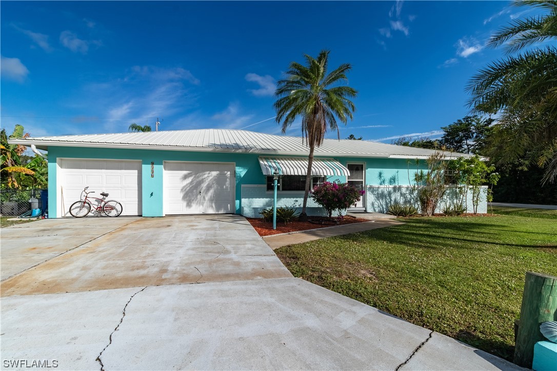 5776 Tarpon Road Bokeelia, FL 33922 - Photo 1 of 31 a front view of a house with garden