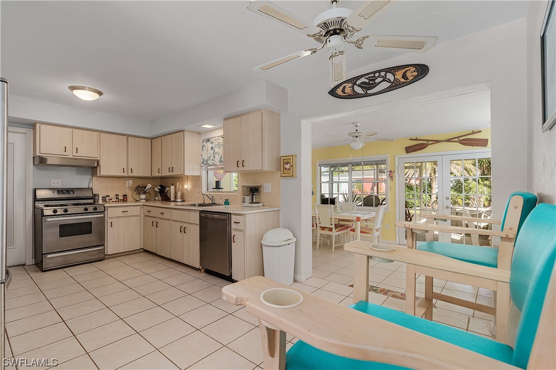 5776 Tarpon Road Bokeelia, FL 33922 - Photo 12 of 31 a kitchen with a stove a sink and a refrigerator
