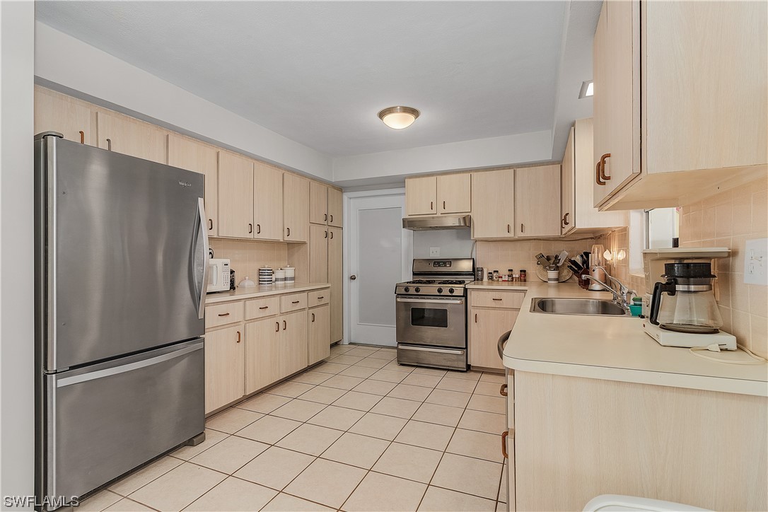 5776 Tarpon Road Bokeelia, FL 33922 - Photo 15 of 31 a kitchen with cabinets stainless steel appliances and a counter space