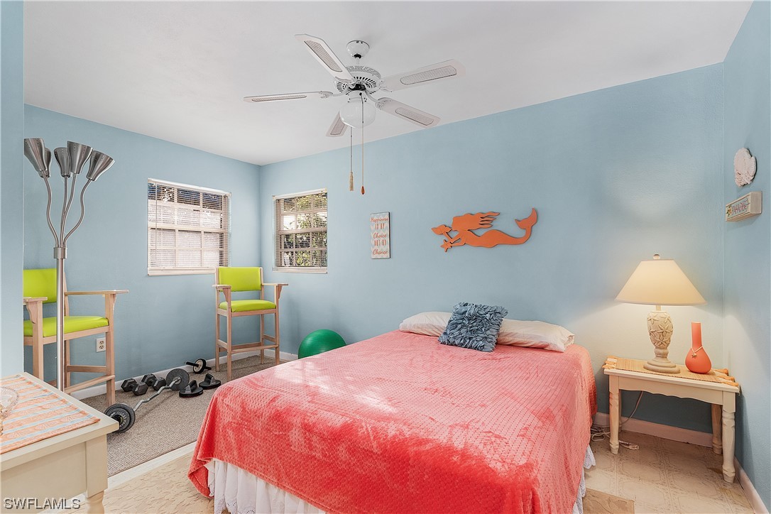 5776 Tarpon Road Bokeelia, FL 33922 - Photo 18 of 31 a bedroom with a bed and a chandelier