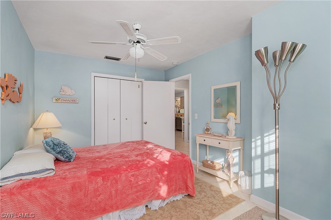 5776 Tarpon Road Bokeelia, FL 33922 - Photo 19 of 31 a bedroom with a bed and a chandelier