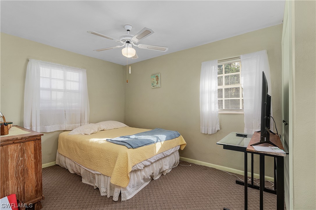 5776 Tarpon Road Bokeelia, FL 33922 - Photo 20 of 31 a bed sitting in a bedroom next to a window