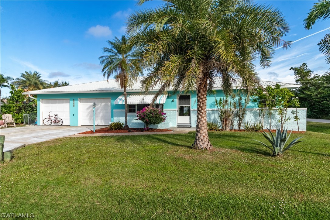 5776 Tarpon Road Bokeelia, FL 33922 - Photo 2 of 31 a view of a house with backyard and a tree