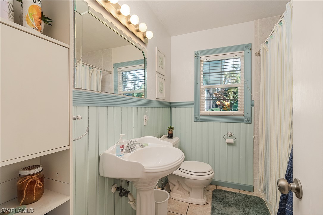 5776 Tarpon Road Bokeelia, FL 33922 - Photo 21 of 31 a bathroom with a sink a toilet and a mirror