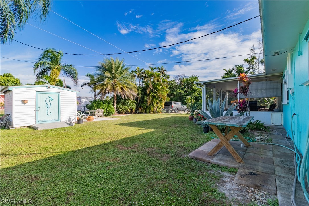 5776 Tarpon Road Bokeelia, FL 33922 - Photo 29 of 31 a view of a patio with table and chairs and potted plants