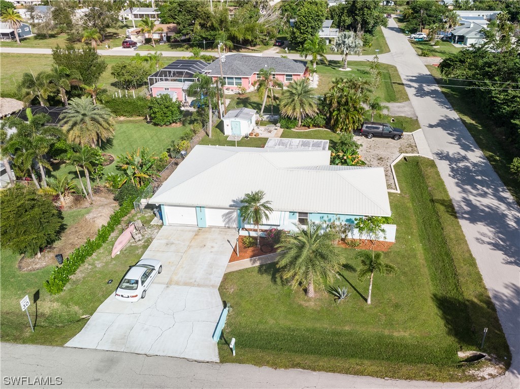 5776 Tarpon Road Bokeelia, FL 33922 - Photo 5 of 31 an aerial view of a house with a yard and lake view